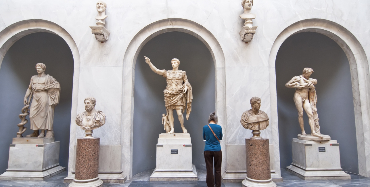 Tourists visiting the statues in the halls of the Vatican Museums in Rome, Italy